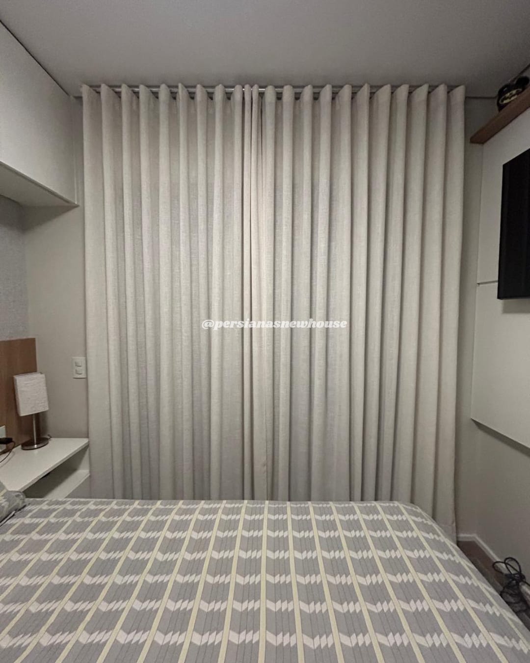Quarto com cortina de tecido em prega ondulada, do teto ao chão